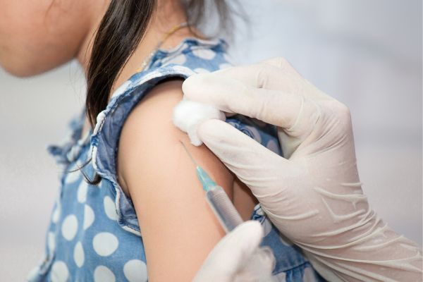 A doctor giving a vaccination to a child.