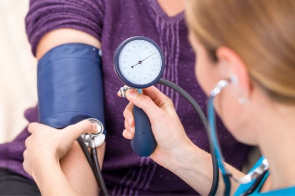 A doctor measuring blood pressure for her patient